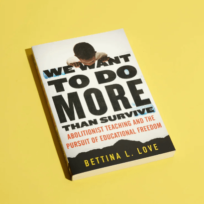 black and white paperback book against a solid yellow background